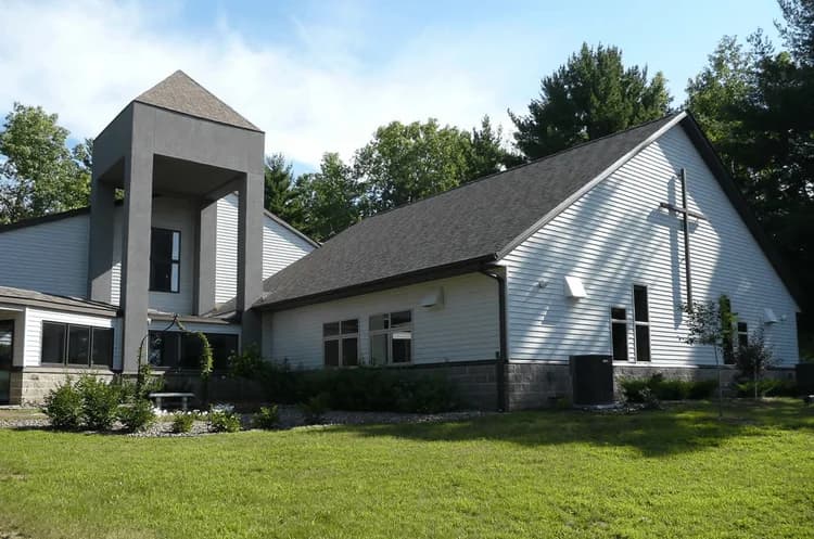 Eau Claire roofing company installing asphalt shingles on a church